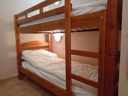 a couple of bunk beds in a room at Apartment in Termignon with Ski-In Ski-Out in Val Cenis