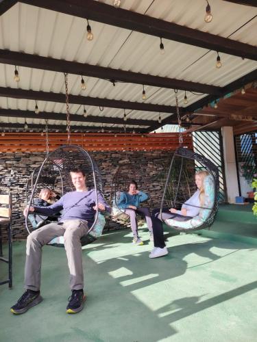 a group of people sitting in swings on a playground at Cabinas Vista Al Golfo in Monteverde Costa Rica