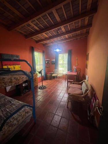 a room with a bedroom with a bed and a table at Gran Quinta en Mercedes con piscina in Mercedes
