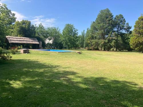 a large grass field with a swimming pool in a park at Gran Quinta en Mercedes con piscina in Mercedes