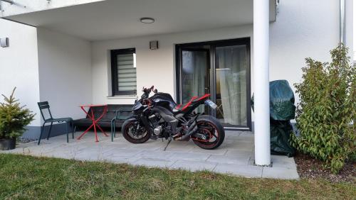 a motorcycle parked in front of a house at Modern ausgestattete Neubauwohnung in Lottstetten