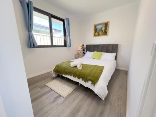 a bedroom with a bed and a window at B2 Airport Adjacent Home - New Amenities & Fast Wi-Fi in Perth