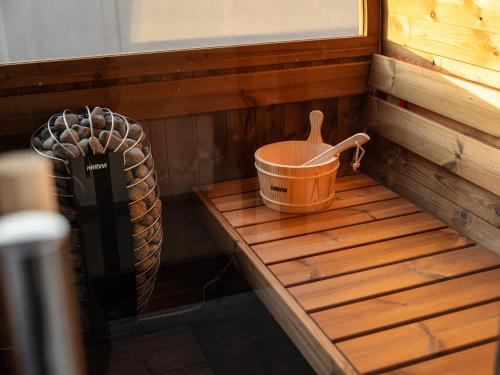 a bucket sitting on a bench in a sauna at LACER OKINAWA NAHA Miebashi in Naha