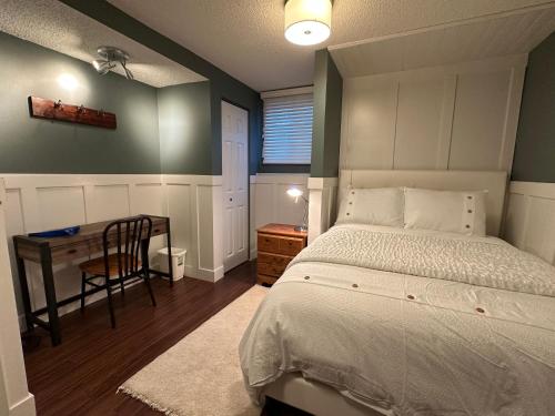 a bedroom with a bed and a desk and a table at 1Bed Cozy Retreat & Spacious Lounge in Yellowknife