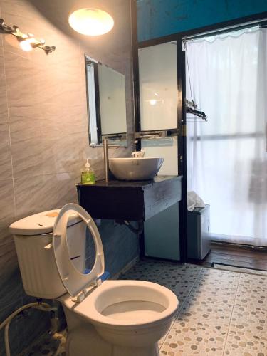 a bathroom with a white toilet and a sink at A La Mer home Vũng Tàu in Vung Tau