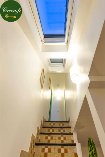 a skylight in the ceiling of a building with stairs at Le Botanique - 15 min Paris et Stade de France - 50m2 - 2 chambres in Aubervilliers