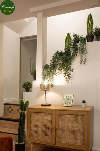 a room with a table with plants on the wall at Le Botanique - 15 min Paris et Stade de France - 50m2 - 2 chambres in Aubervilliers