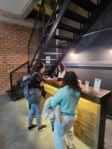 a group of people standing around a table at Hotel The Roof in León