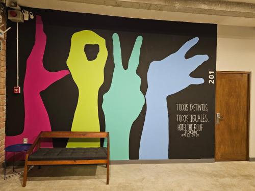 a wall mural in a room with a chair at Hotel The Roof in León