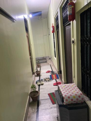 a hallway with a room with a door and a table at Prabhu kunj homestay in Prayagraj