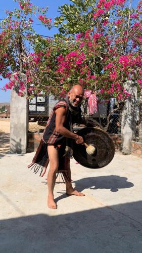 a man in a dress holding a basket at Khu Du Lịch Sinh Thái, Nghỉ dưỡng Homestay Hoàng Ánh - Kon Xom Luh in Kon Tum