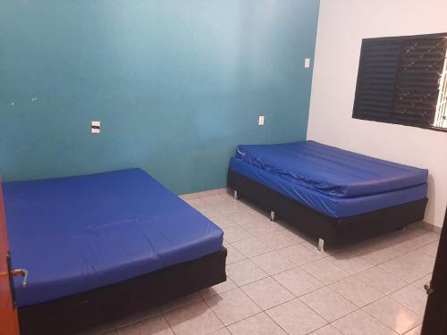 Ένα ή περισσότερα κρεβάτια σε δωμάτιο στο Casa para temporada Doces Sonhos