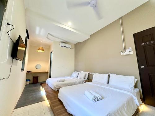 Ένα ή περισσότερα κρεβάτια σε δωμάτιο στο Bahari 58