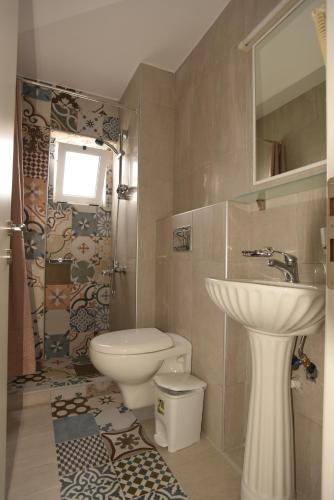 a bathroom with a sink and a toilet and a shower at Paleochora Elizabeth Apartments in Palaiochora