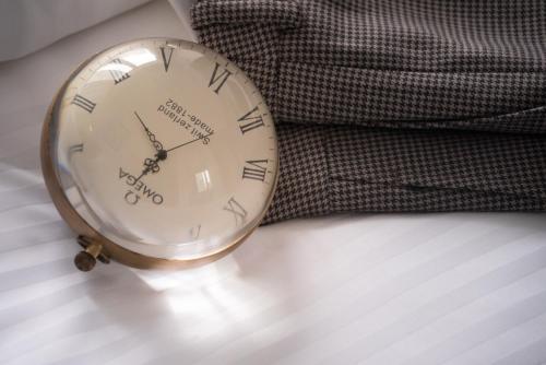 a gold clock sitting on top of a bed at attitude on granville in Hong Kong