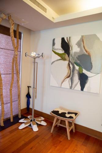 a room with a bench and a painting on the wall at Suite of Naithon beachfront apartment in Nai Thon Beach