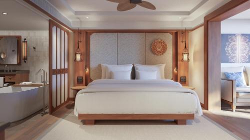 a bedroom with a large bed and a bathroom at Paradisus by Meliá Bali in Nusa Dua