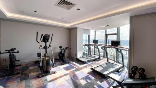 a gym with treadmills and elliptical machines at Mercure Xiamen Zhongshan Road Pedestrian Street Seaview in Xiamen