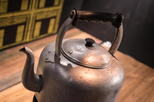 an old metal tea kettle sitting on a table at attitude on granville in Hong Kong