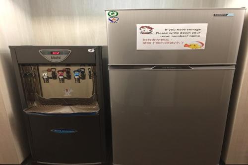a refrigerator with a sign on top of it at Ark Hotel - Changan Fuxing方舟商業股份有限公司 in Taipei