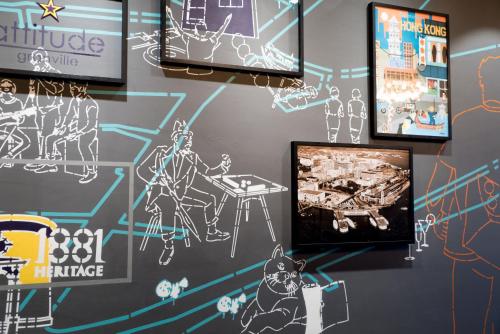 a wall with drawings on a wall with a tv at attitude on granville in Hong Kong