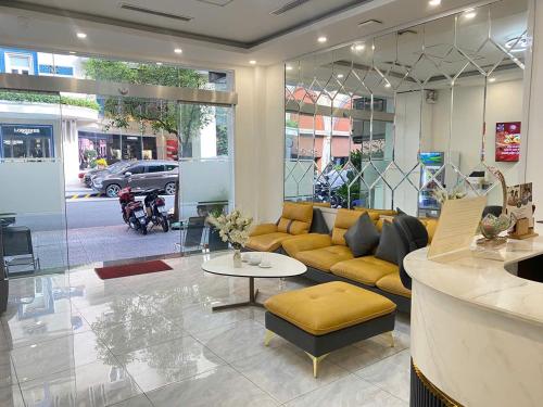 a living room with a couch and a table at A25 Hotel - 14 Hồ Huấn Nghiệp in Ho Chi Minh City