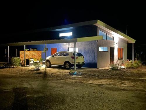 a car parked in front of a house at night at Casa Celeste Río Grande in Paquera