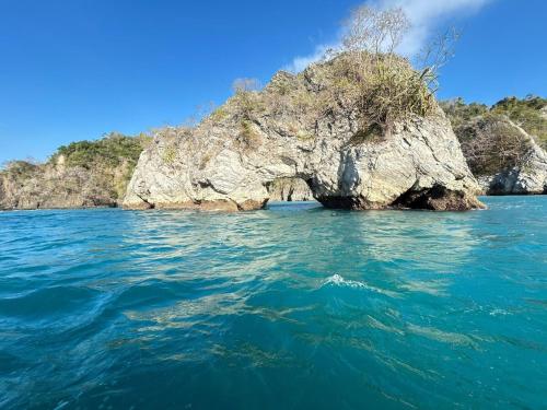 an island in the middle of a body of water at Casa Celeste Río Grande in Paquera