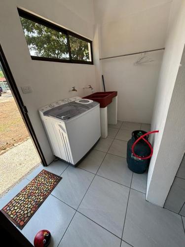 a washing machine sitting on the floor of a house at Casa Celeste Río Grande in Paquera