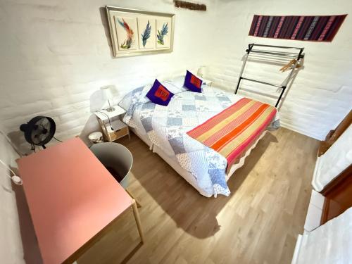 a small bedroom with a bed and a desk at Atacama Lodge Rukazen Rústico in San Pedro de Atacama