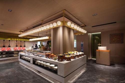a buffet in a restaurant with food on display at Hampton by Hilton Baoding High-tech Zone in Baoding