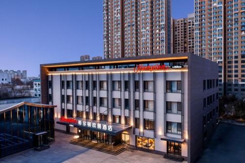 a hotel building with lights on top of it at Hampton by Hilton Baoding High-tech Zone in Baoding