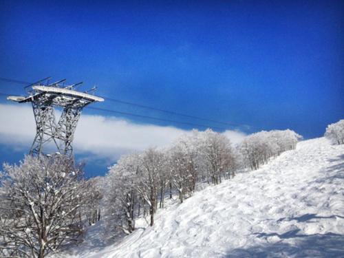 a ski lift tower on a snow covered slope at Pension Come Healing Tatami-room- Vacation STAY 14980 in Minami Uonuma
