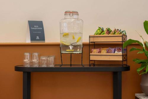 a table with a bottle of water and glasses on it at Quality Hotel Hampstead in London