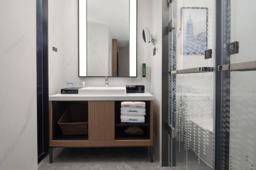 a bathroom with a sink and a shower at Hampton by Hilton Baoding High-tech Zone in Baoding