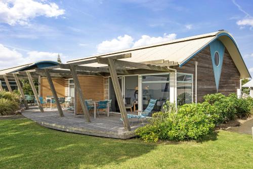 a house with a deck with a roof at Tasman Holiday Parks - Papamoa Beach in Papamoa