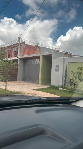 a house with a garage in front of it at Casa 2 quartos, completa, com churrasqueira e garagem - Villa Bella in Nova Mutum