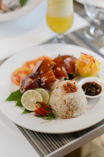 a white plate of food on a table with rice at Seda Central Bloc Cebu in Cebu City