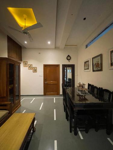 a dining room with a table and chairs at Tasya Villa in Udaipur