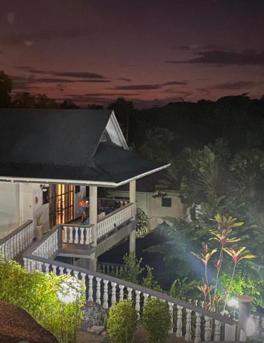 a night view of a house with a roof at Hotel Chateau St Cloud in La Digue