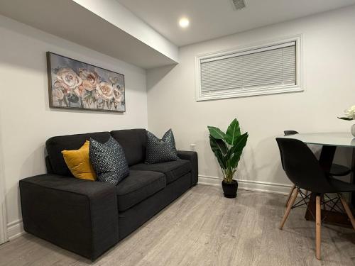 a living room with a couch and a table at Modern 2BR in the Heart of Little Italy in Toronto