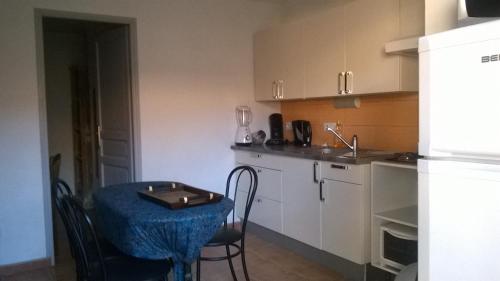 a small kitchen with a table and a sink at Appartement Croisette in Sainte-Maxime