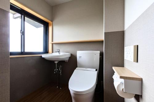 a bathroom with a toilet and a sink at Ichiboukan Hanare Kai in Kyotango