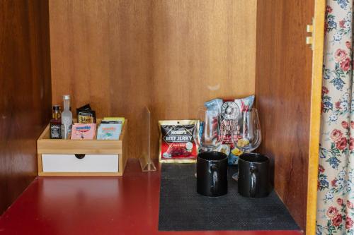 a shelf with two mugs on a table at Yarra Valley Grand in Yarra Glen