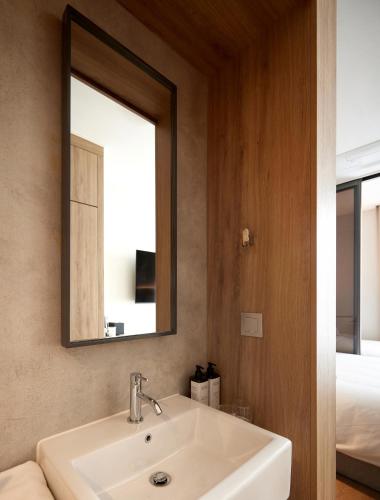 a bathroom with a sink and a mirror at HOMES Stay MyeongDong in Seoul