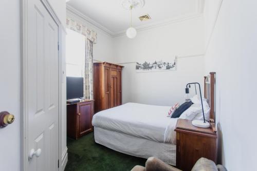 a bedroom with a bed and a television in it at Yarra Valley Grand in Yarra Glen