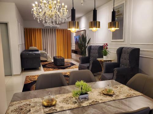 a living room with a dining table and chairs at farissa homestay in Melaka