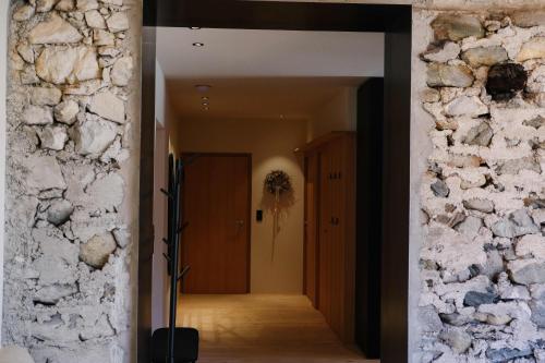 a hallway of a house with a stone wall at das 1494 Wohnen und Kultur im Denkmal in Mieming