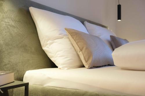 a group of pillows sitting on a bed at das 1494 Wohnen und Kultur im Denkmal in Mieming