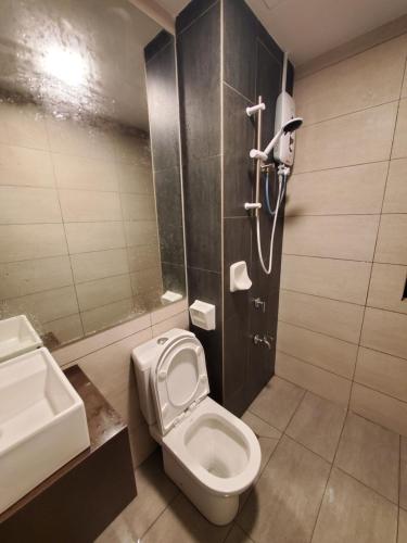 a bathroom with a toilet and a sink and a shower at farissa homestay in Melaka